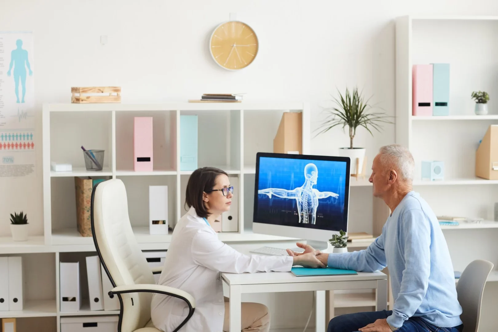A doctor consulting with a patient at her desk